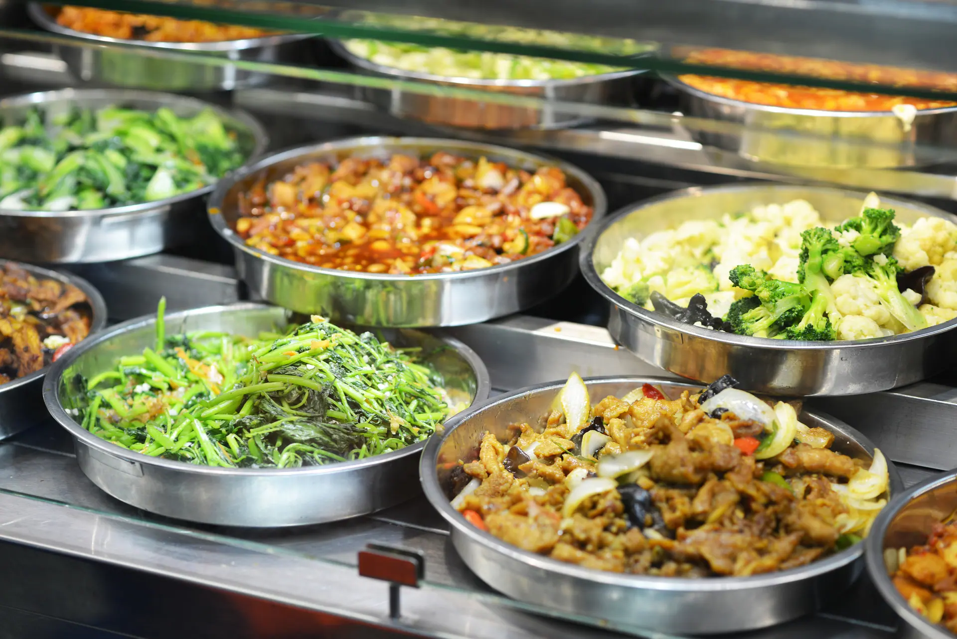 Stainless trays of vegetables and noodles