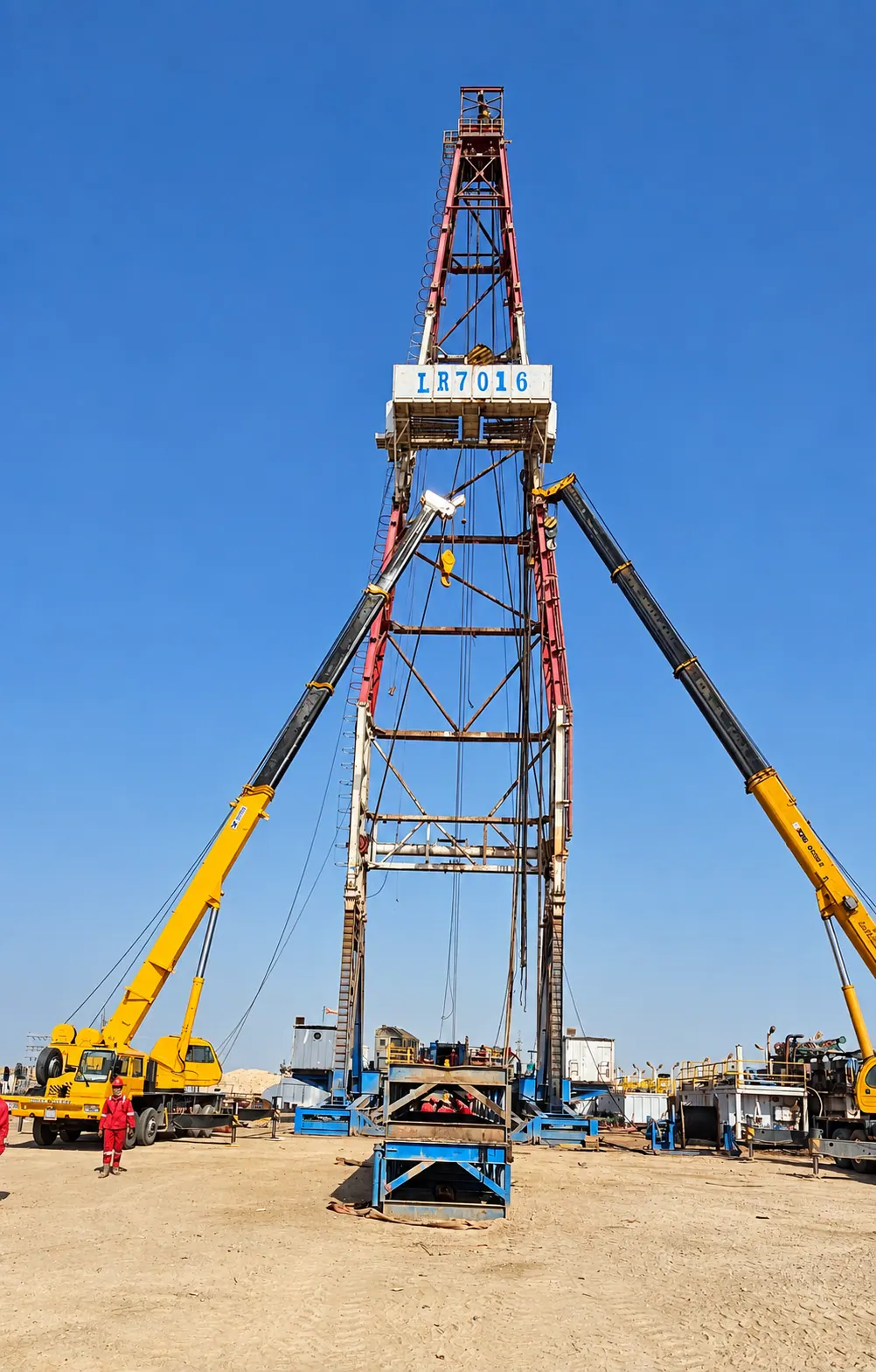 Derrick raised with crane support during rig-up